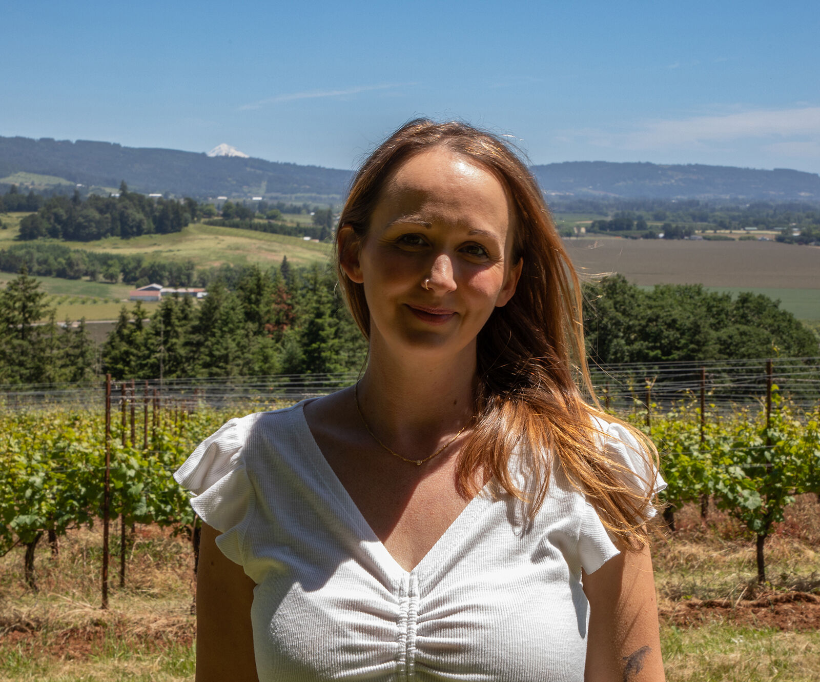 Jessica Burkhart in front of Penner-Ash estate vineyard